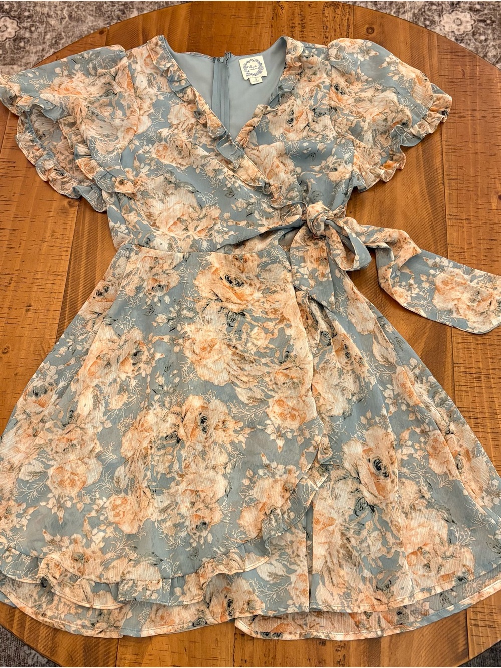 Blue Rain Junior’s Floral Wrap Dress in Blue and Peach
0411